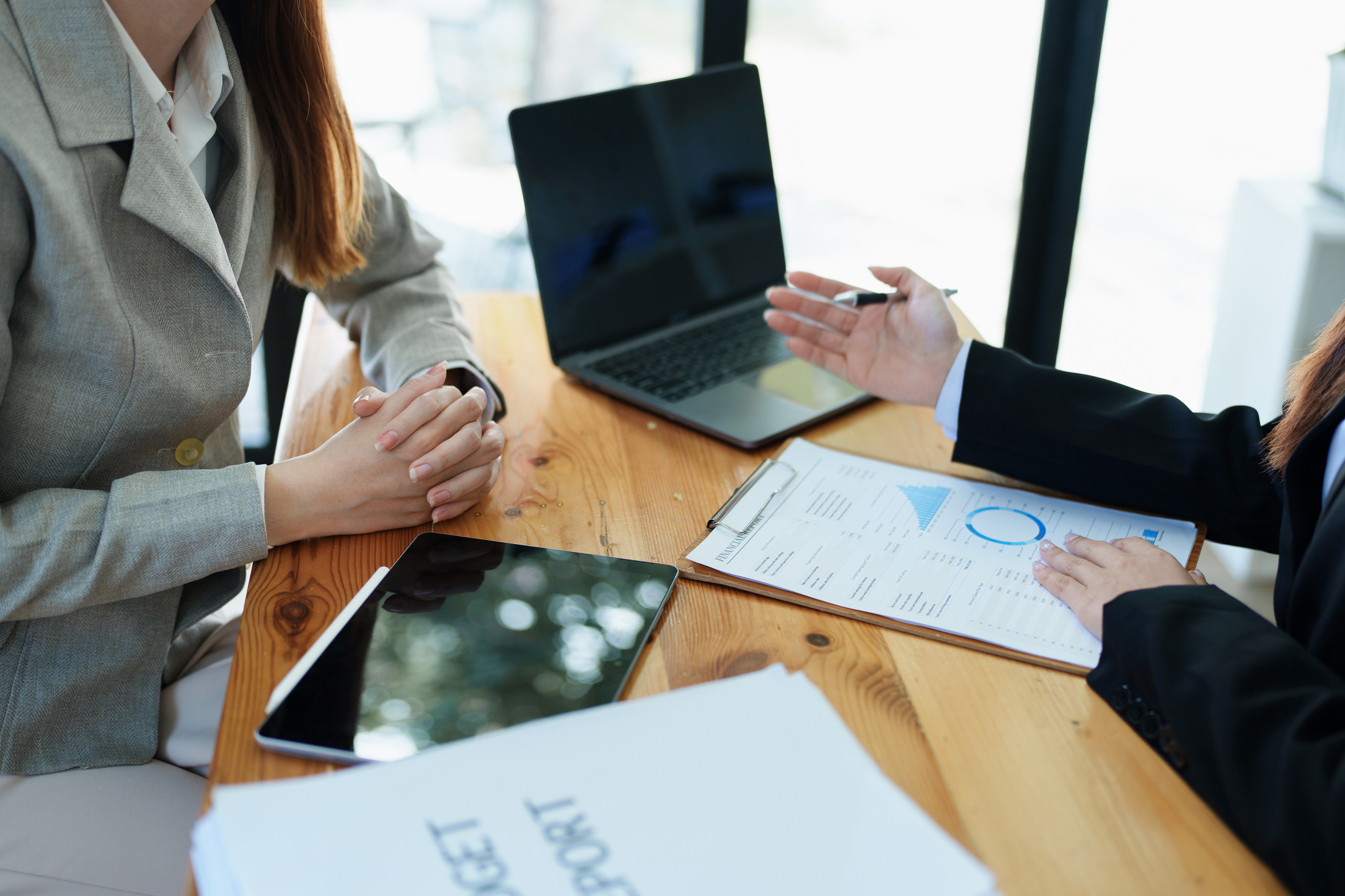 Financial analysts analyzing business reports on planned investm